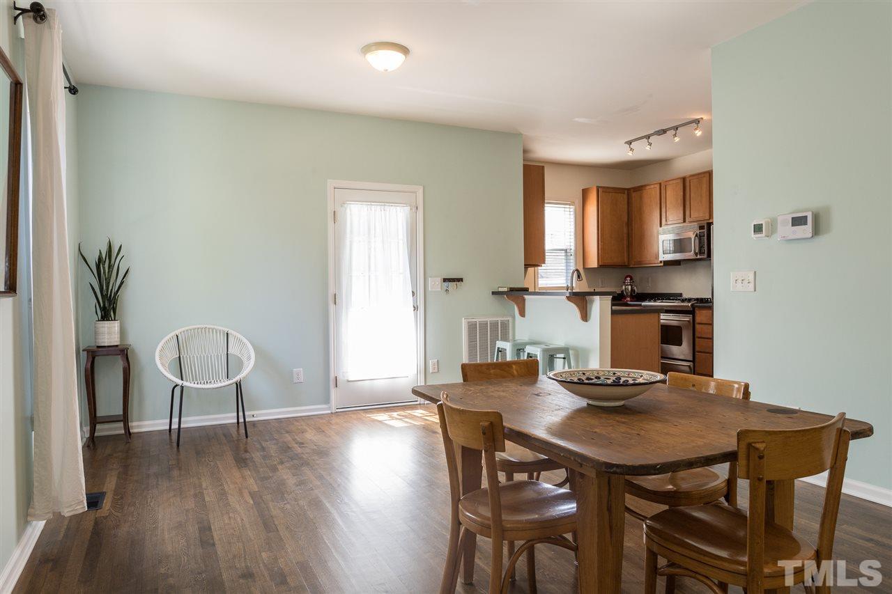 233 Cooke Street Raleigh, NC 27601 - Photo 5 of 27 The kitchen opens via a breakfast bar to the back portion of the main living space, whether you want it to be a breakfast spot, sitting area, work area, or anything else.