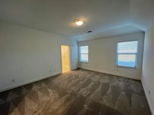 a bathroom with a shower and a glass door