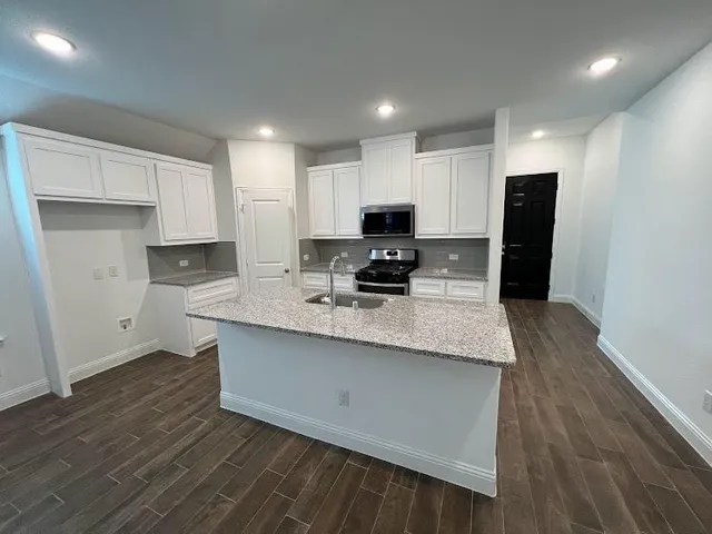 a kitchen with stainless steel appliances a refrigerator sink and microwave