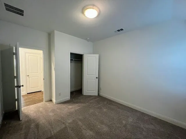 an empty room with closet area