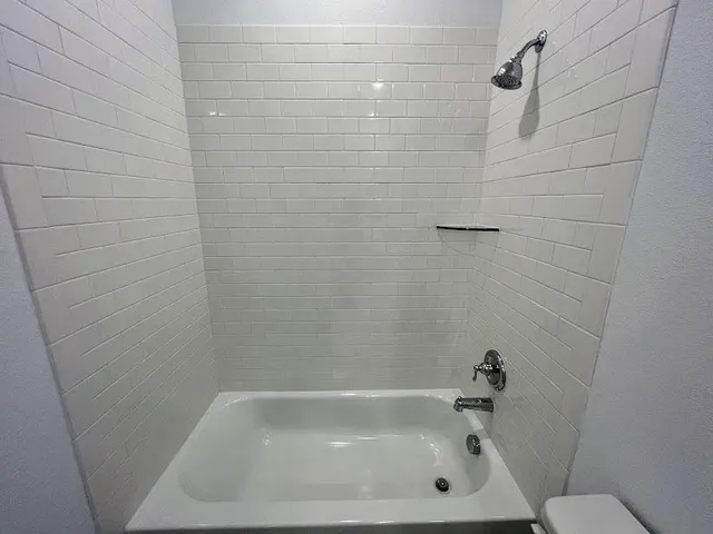 an empty room with closet and wooden floor