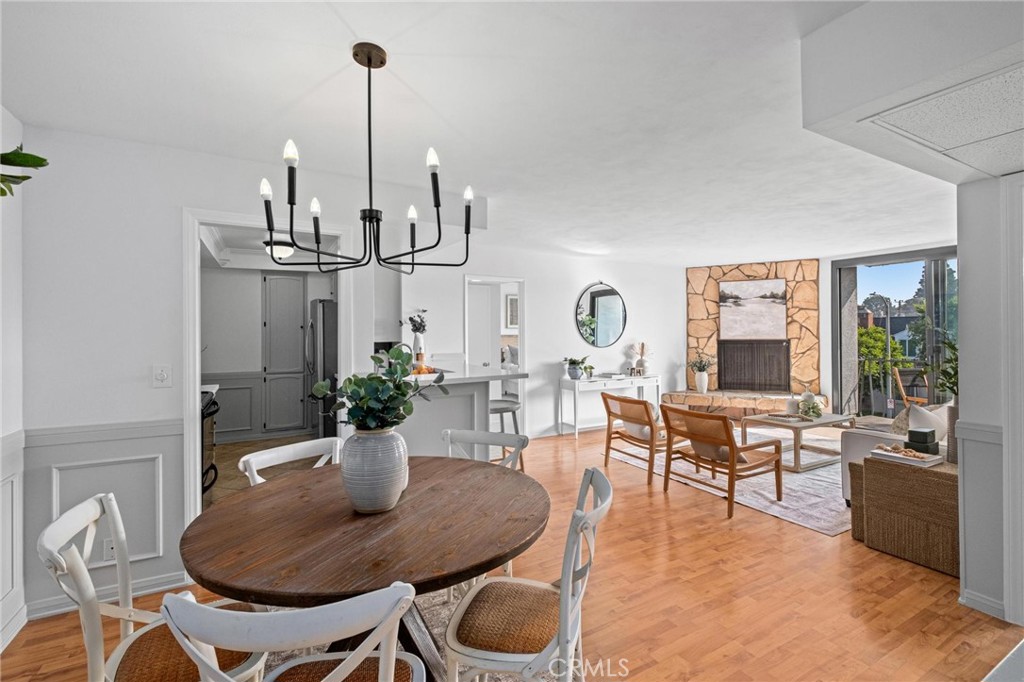 a view of a dining room with furniture wooden floor and chandelier