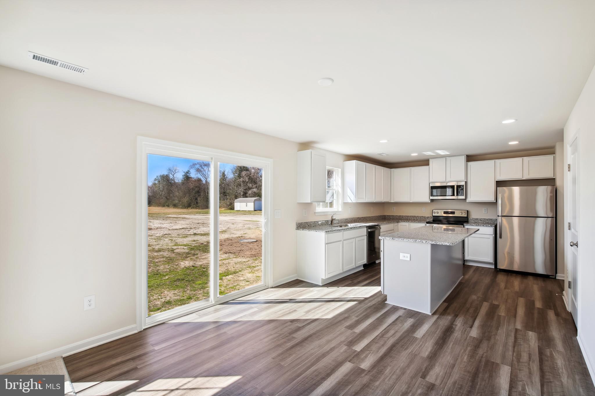 26553 Line Road Seaford, DE 19973 - Photo 7 of 22 a kitchen with a refrigerator and wooden cabinets