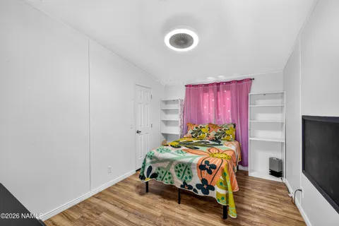a view of a livingroom with wooden floor and cabinet