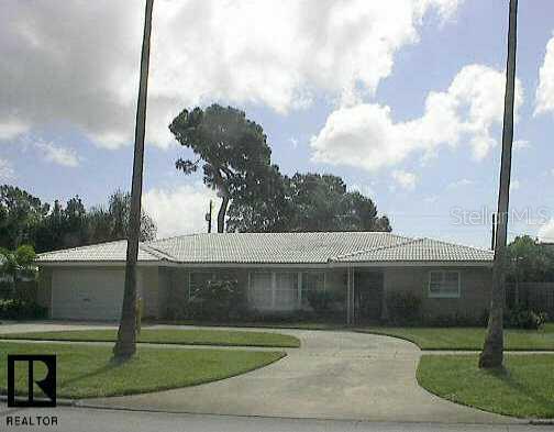 1343 Indian Rocks Road Belleair, FL 33756 - Photo 1 of 1 a front view of a house with a garden
