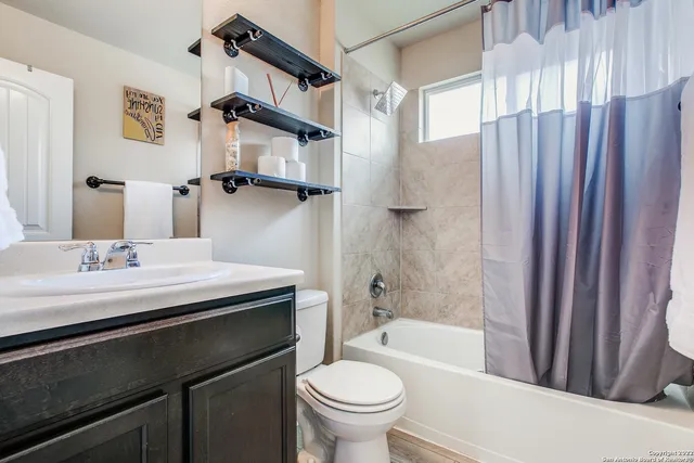 a bathroom with a sink a toilet and a bathtub