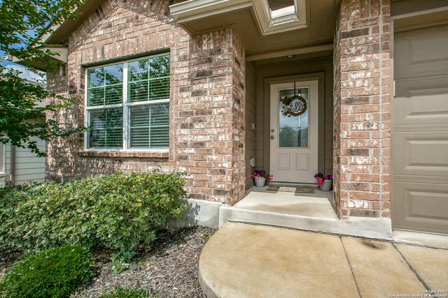 a view of a brick house with potted plants