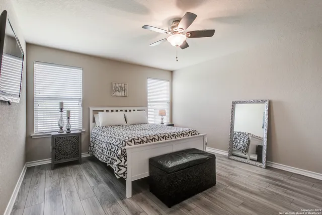 a spacious bedroom with a bed and a window