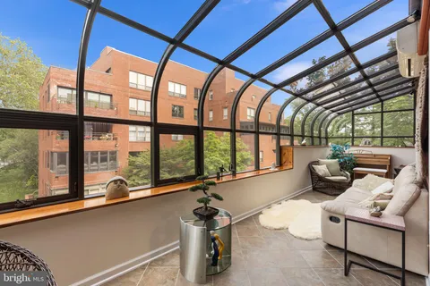 a view of an empty room with window and fire place