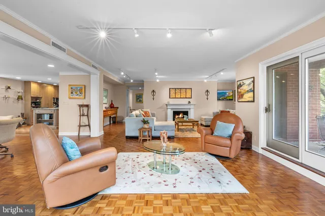 a view of empty room with wooden floor and fireplace