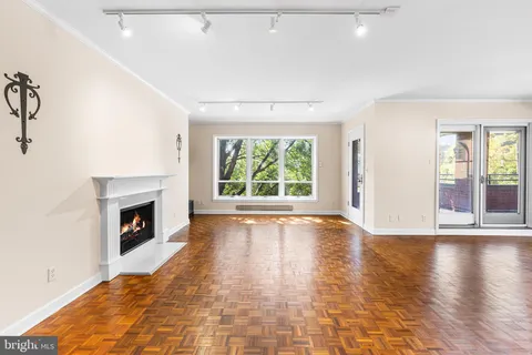 a view of an entryway with table wooden floor and window