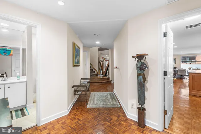 a living room with fireplace furniture and a book shelf