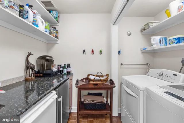 a work room with furniture a rug and a large window