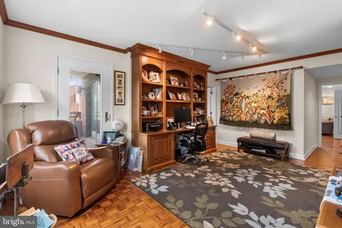 a living room with furniture a rug and a flat screen tv