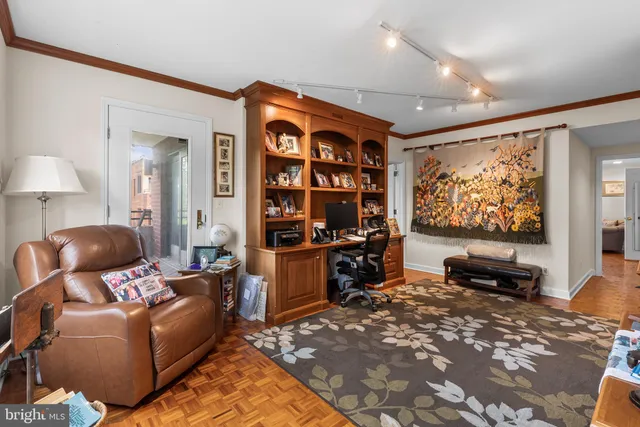 a living room with furniture a rug and a flat screen tv