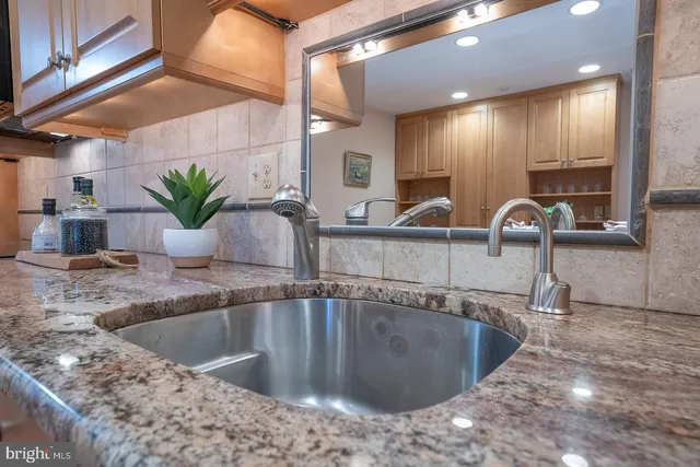 a view of a livingroom with furniture and a large window