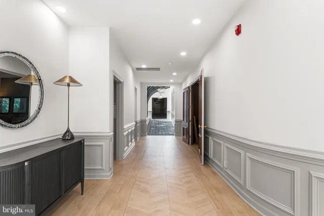 a view of an empty room with stairs and furniture