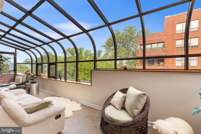 a living room with furniture rug and wooden floor