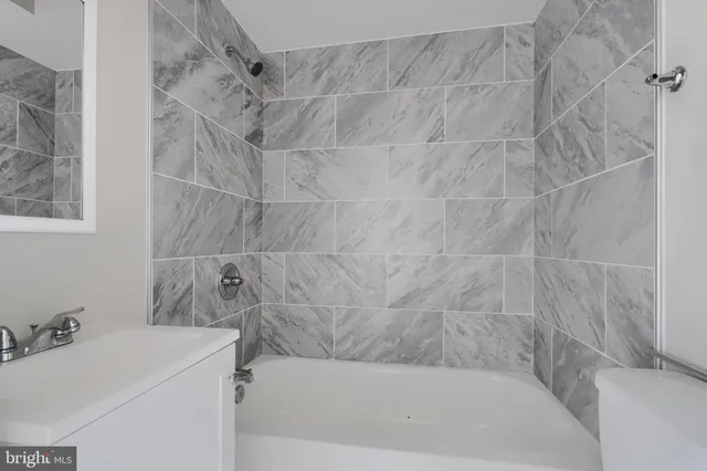 a bathroom with a sink and a bath tub