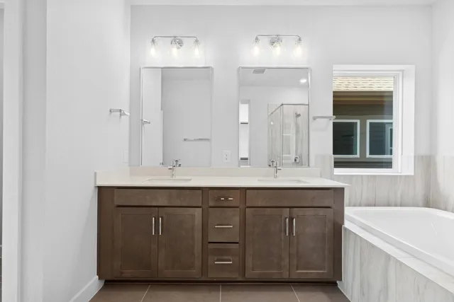 a bathroom with a sink double vanity and a mirror