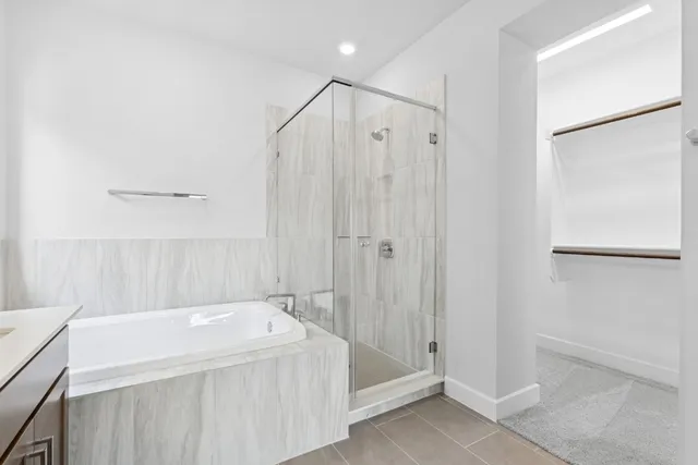 a bathroom with a bathtub and a shower