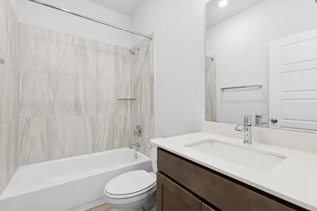 a bathroom with a sink a toilet a bathtub and shower