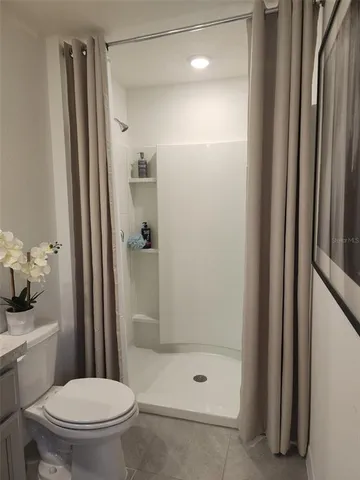 a bathroom with a shower and a toilet
