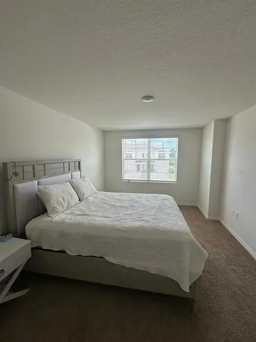 a bedroom with a bed and window