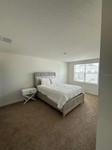 a bedroom with a bed and window