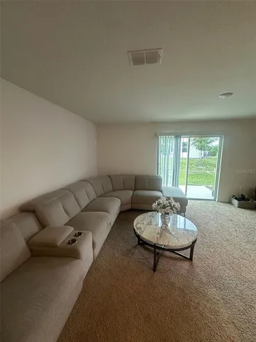 a living room with furniture and a table