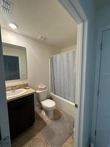 a bathroom with a sink toilet and mirror