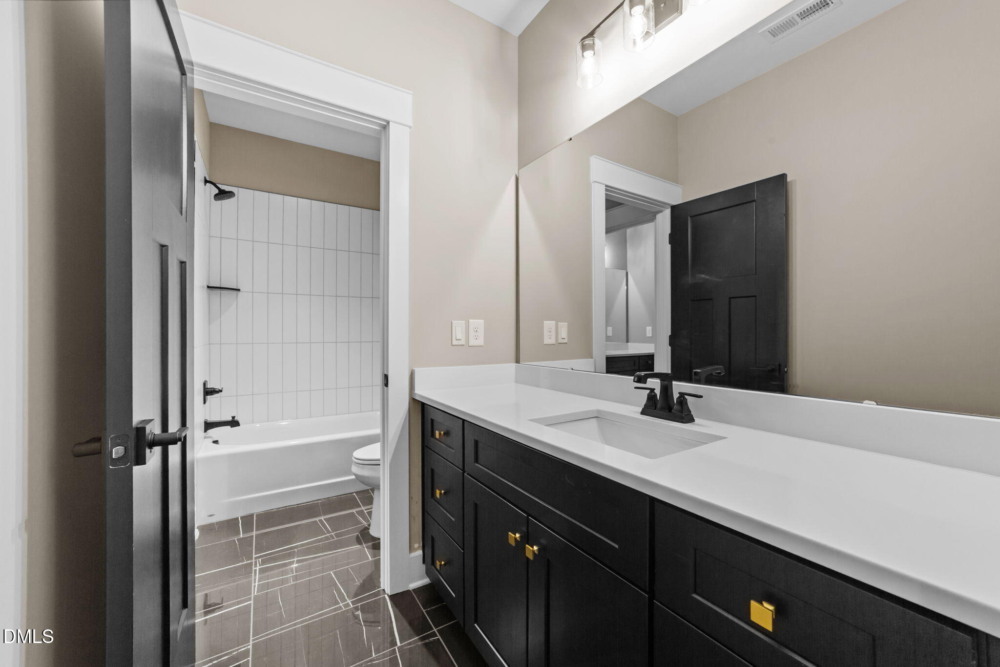 2590 Lassiter Road Four Oaks, NC 27524 - Photo 47 of 72 a bathroom with a double vanity sink and a mirror