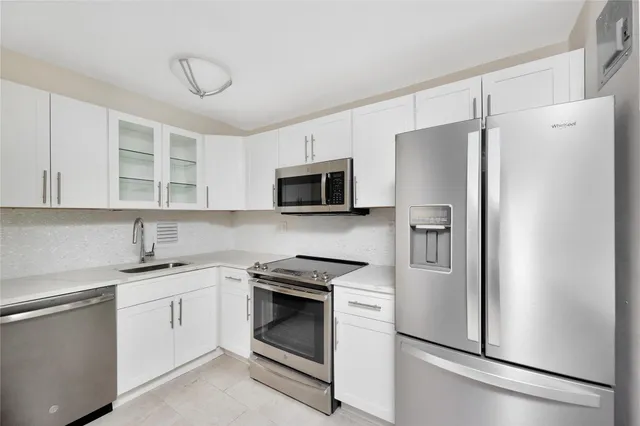 a kitchen with a refrigerator sink and microwave