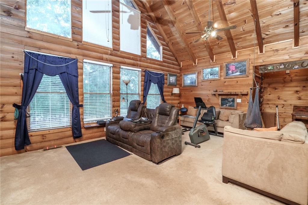 1840 Double Springs Church Road Monroe, GA 30656 - Photo 11 of 73 a living room with furniture a floor to ceiling window and a flat screen tv
