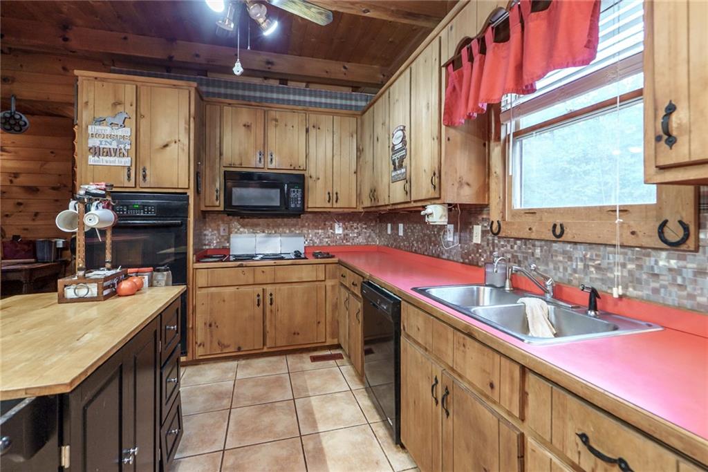 1840 Double Springs Church Road Monroe, GA 30656 - Photo 15 of 73 a kitchen with a sink stove and cabinets