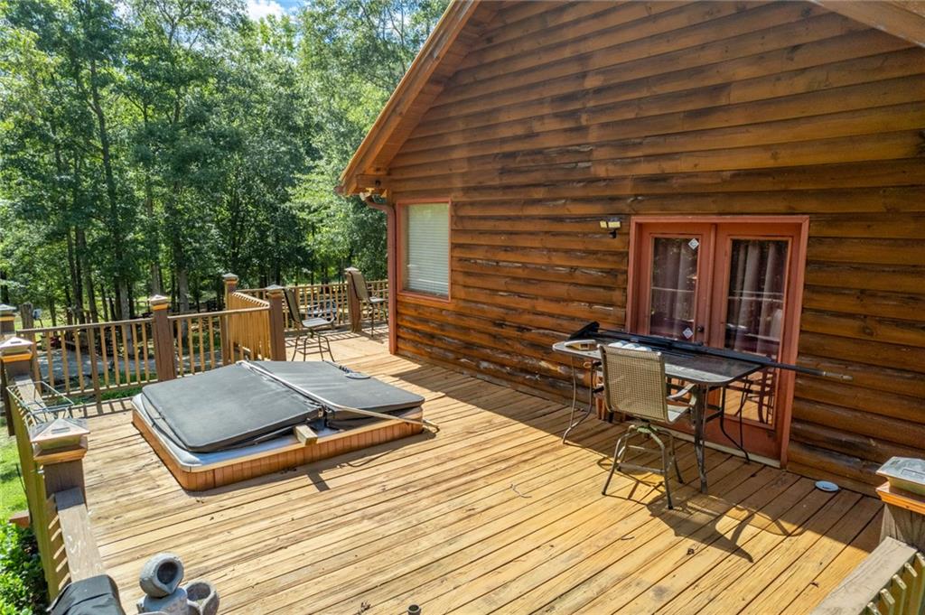1840 Double Springs Church Road Monroe, GA 30656 - Photo 21 of 73 a view of a roof deck with wooden floor and outdoor seating