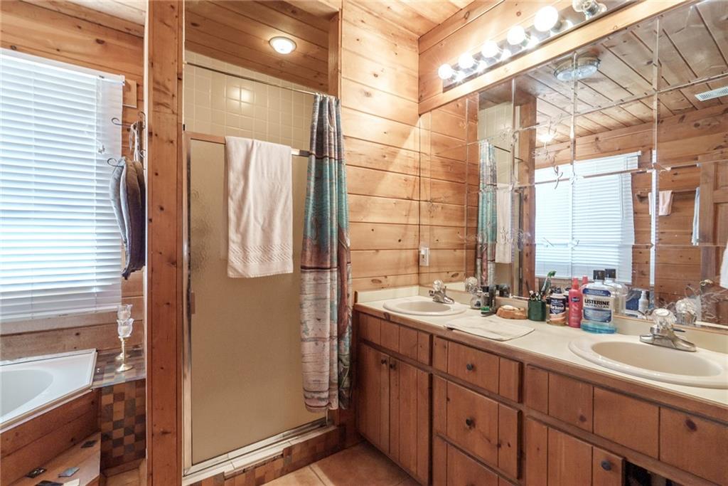 1840 Double Springs Church Road Monroe, GA 30656 - Photo 23 of 73 a bathroom with a double vanity sink and mirror