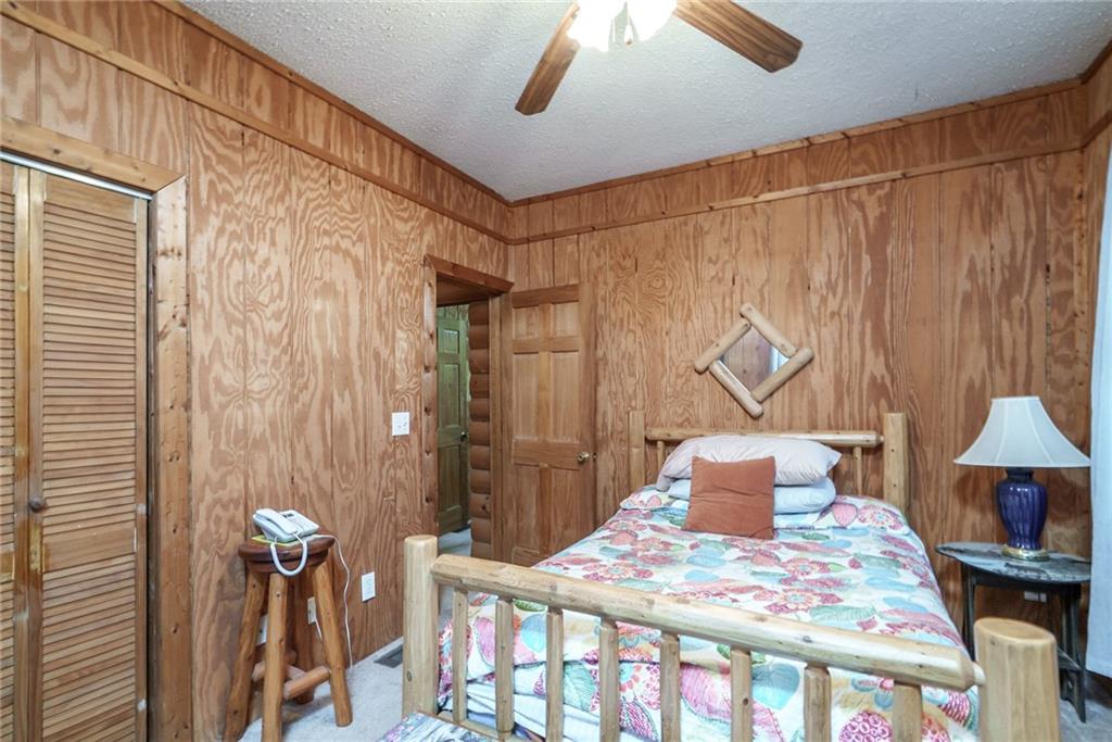 1840 Double Springs Church Road Monroe, GA 30656 - Photo 28 of 73 a bedroom with a bed and a chandelier