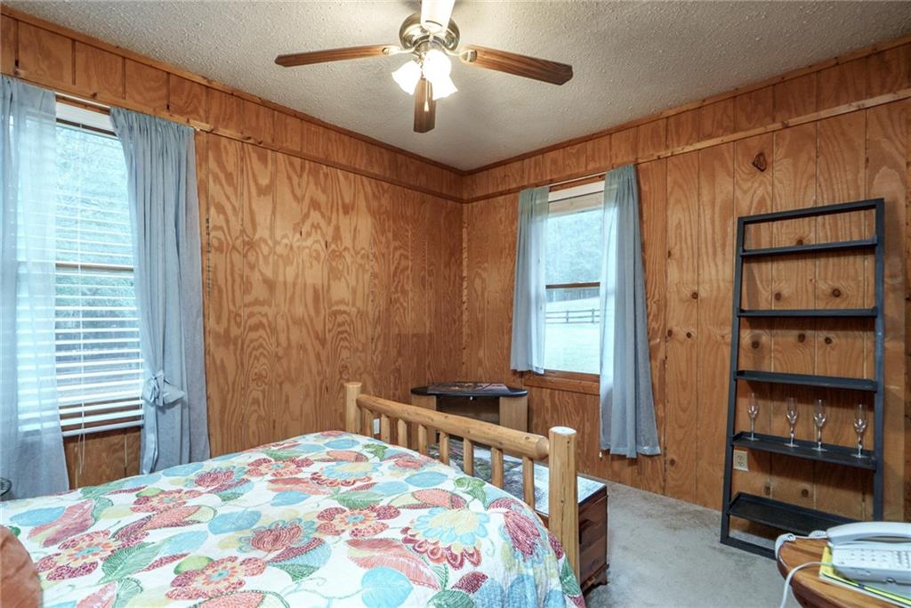 1840 Double Springs Church Road Monroe, GA 30656 - Photo 29 of 73 a bedroom with a bed and a chandelier