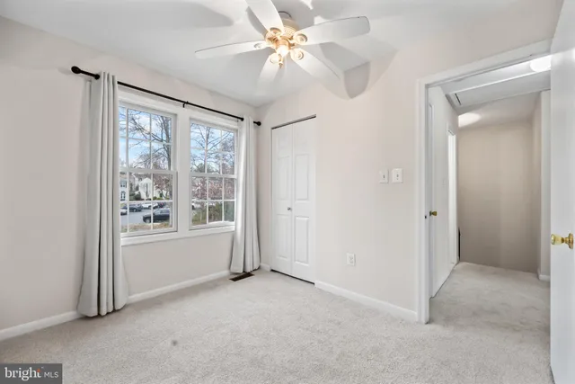 a bathroom with a granite countertop sink a toilet and a mirror