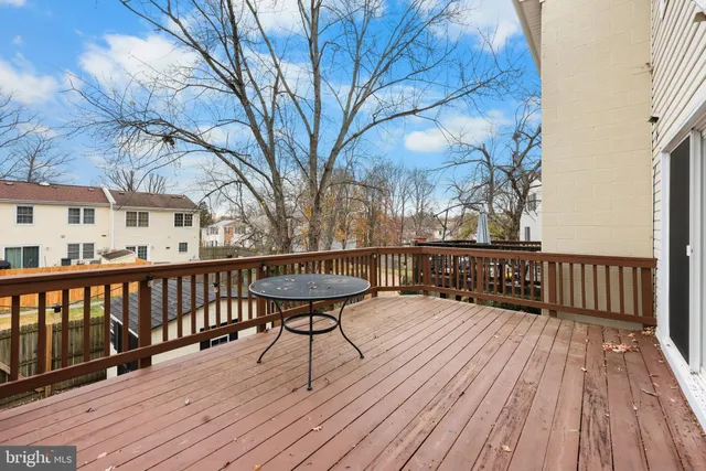a view of a roof deck with wooden floor and seating space