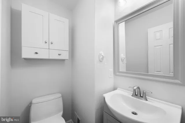 a bathroom with a sink a toilet and mirror