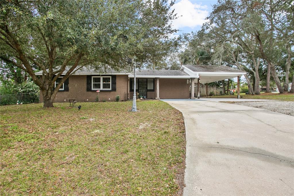 139 Floridana Road DeBary, FL 32713 - Photo 1 of 1 a front view of house with yard and trees around
