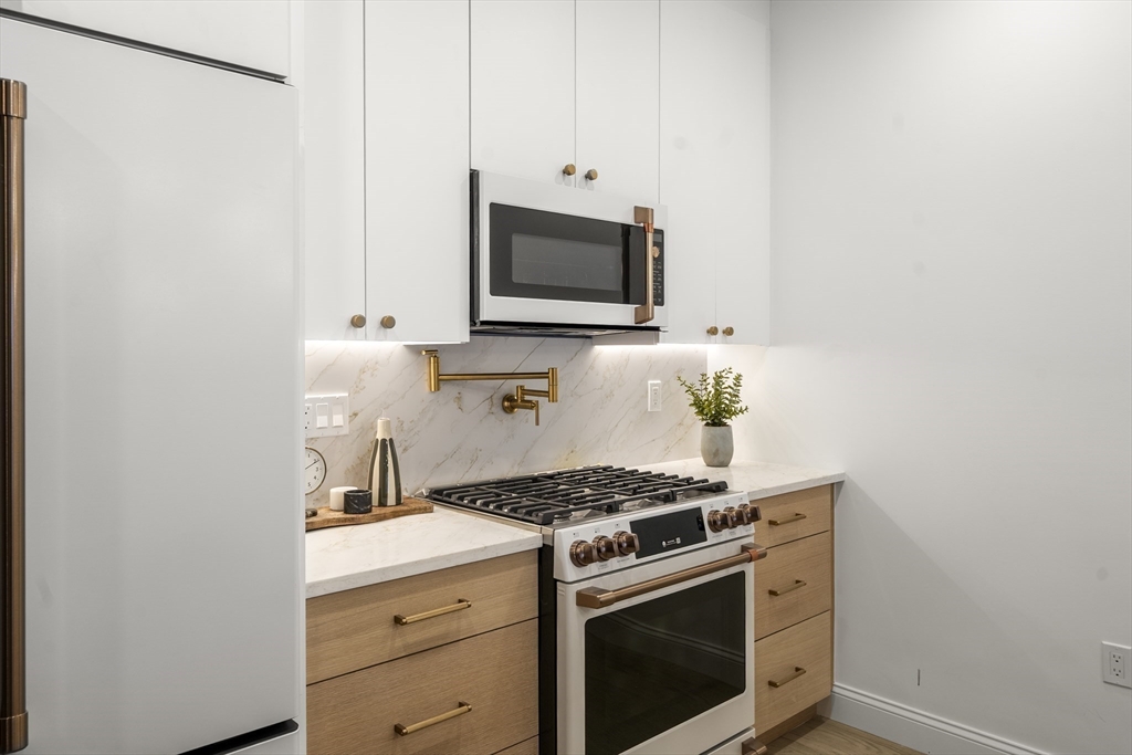51 North Margin Street, Unit 3 Boston, MA 02113 - Photo 4 of 19 a kitchen with a stove and a microwave