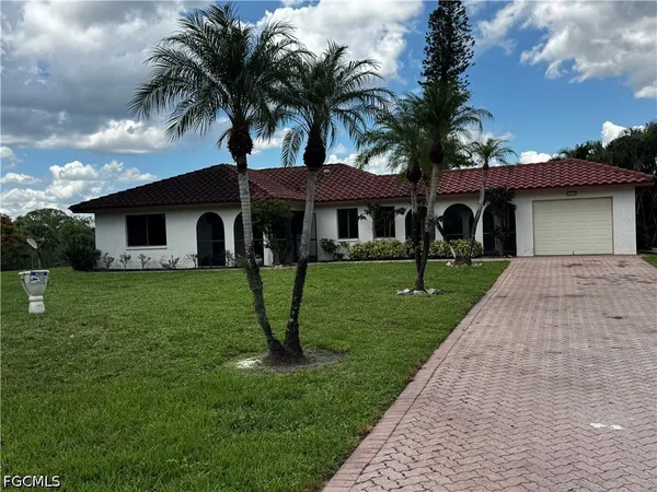 a front view of house with yard and green space