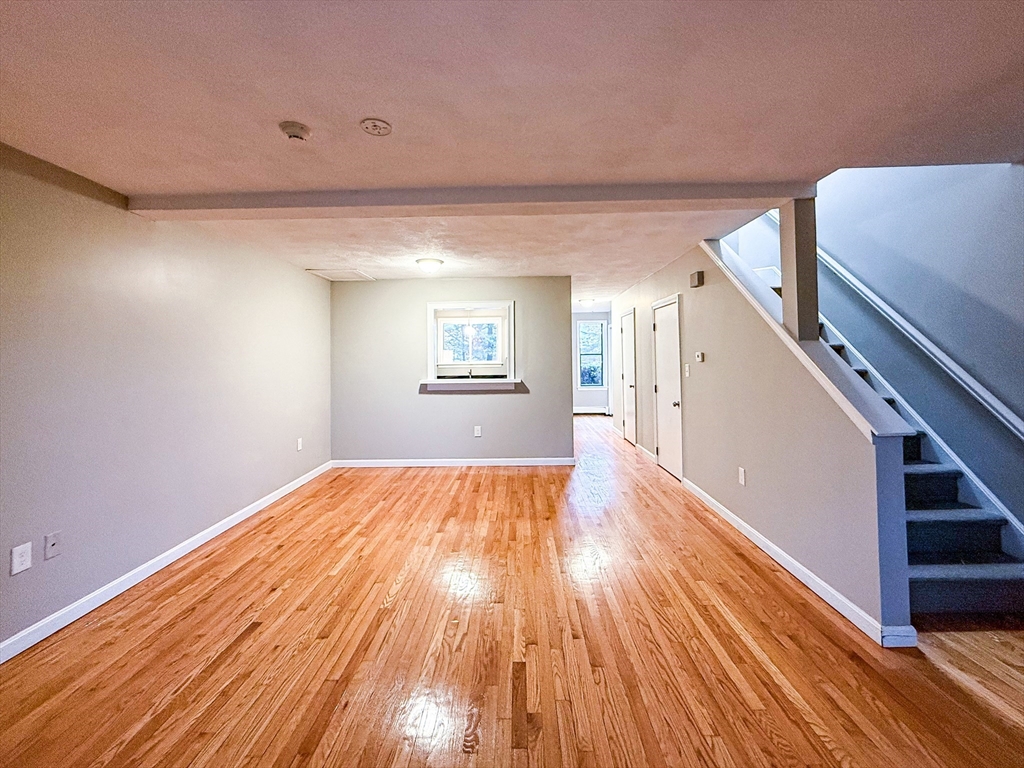 24 Wilson Street, Unit 4 Marlborough, MA 01752 - Photo 11 of 29 a view of an empty room with wooden floor and a window