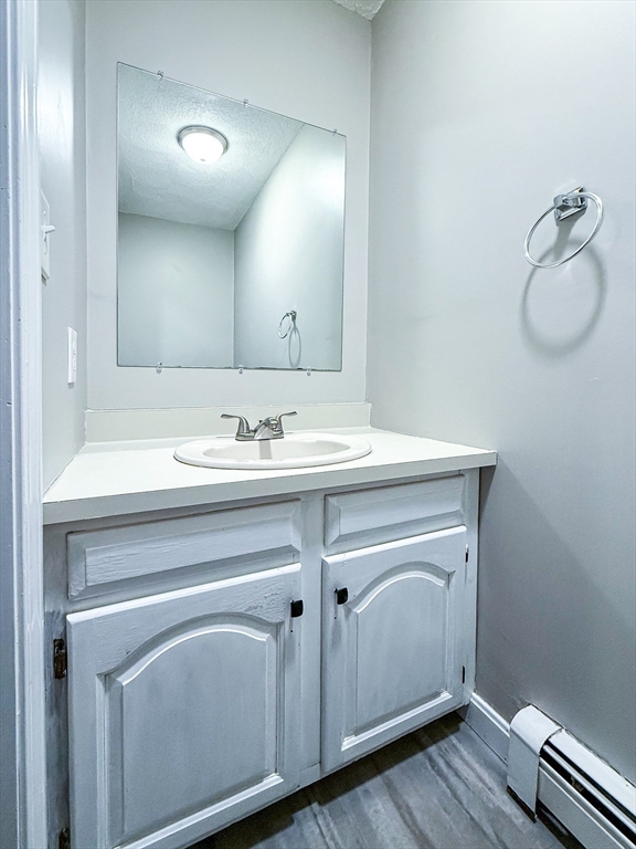 24 Wilson Street, Unit 4 Marlborough, MA 01752 - Photo 12 of 29 a bathroom with a sink vanity and mirror