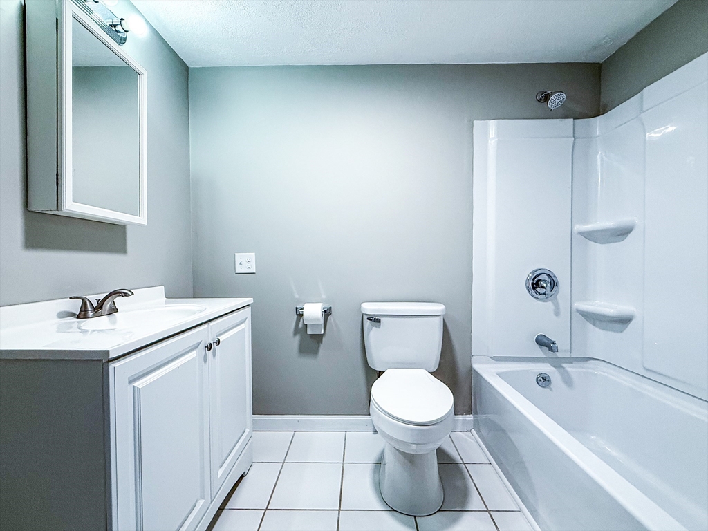 24 Wilson Street, Unit 4 Marlborough, MA 01752 - Photo 13 of 29 a bathroom with a sink a toilet and shower