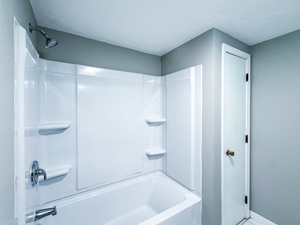 24 Wilson Street, Unit 4 Marlborough, MA 01752 - Photo 14 of 29 a bathroom with a shower and a tub
