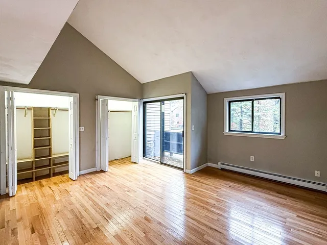 a view of an empty room and wooden floor